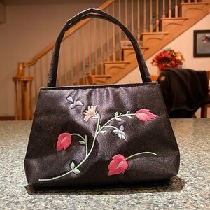 Black micro purse with floral embroidery on front Double handle and snap closure